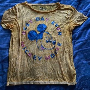 Yellow mickey mouse t shirt brand is Disney.